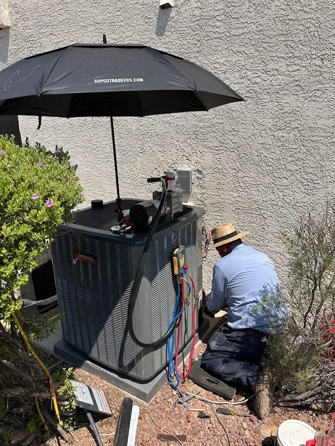 HVAC technician performing outdoor AC maintenance in Beverly Hills